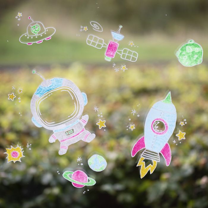 Décorations de fenêtres avec des motifs de l’espace à l’aide de marqueurs à craie