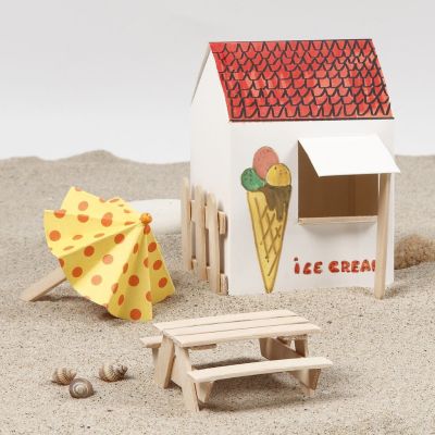 Un parasol et une table de pique-nique avec deux bancs faits avec des b&acirc;tons de friskos