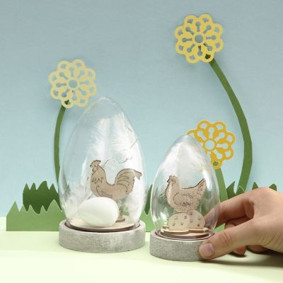 Une cloche en verre décorée avec une figurine de Pâques à assembler