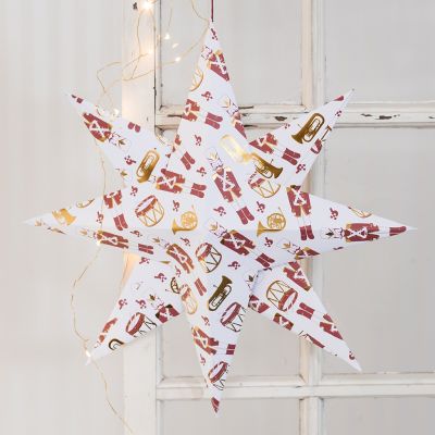 Une grande étoile pliée en papier de design avec un motif de casse-noisette.